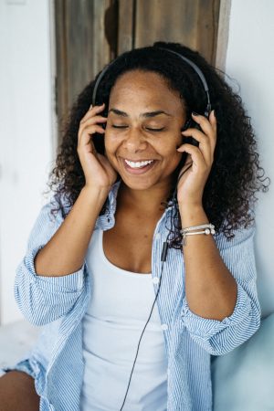 RezlCare Woman Smiling Holding Headphones